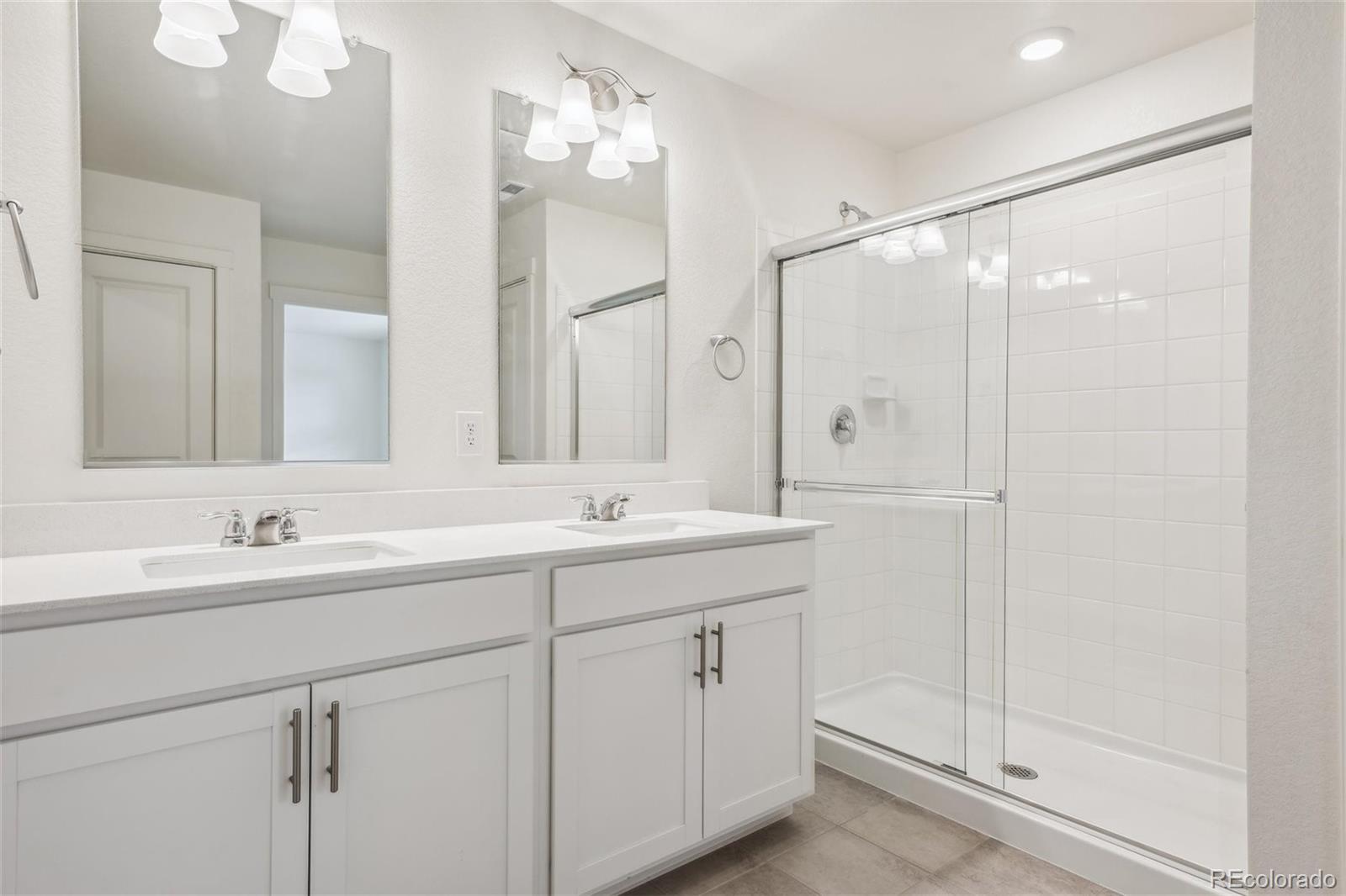 3482 Belleville Ridge Road Elizabeth, CO 80107 - Photo 13 of 21 a bathroom with a double vanity sink mirror and