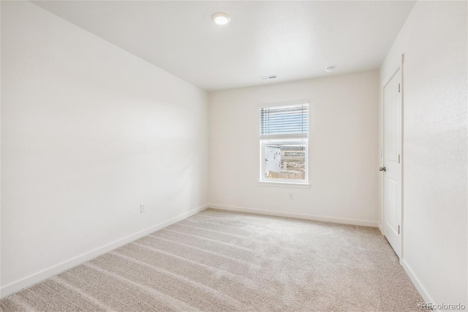 3482 Belleville Ridge Road Elizabeth, CO 80107 - Photo 15 of 21 a view of an empty room with a window
