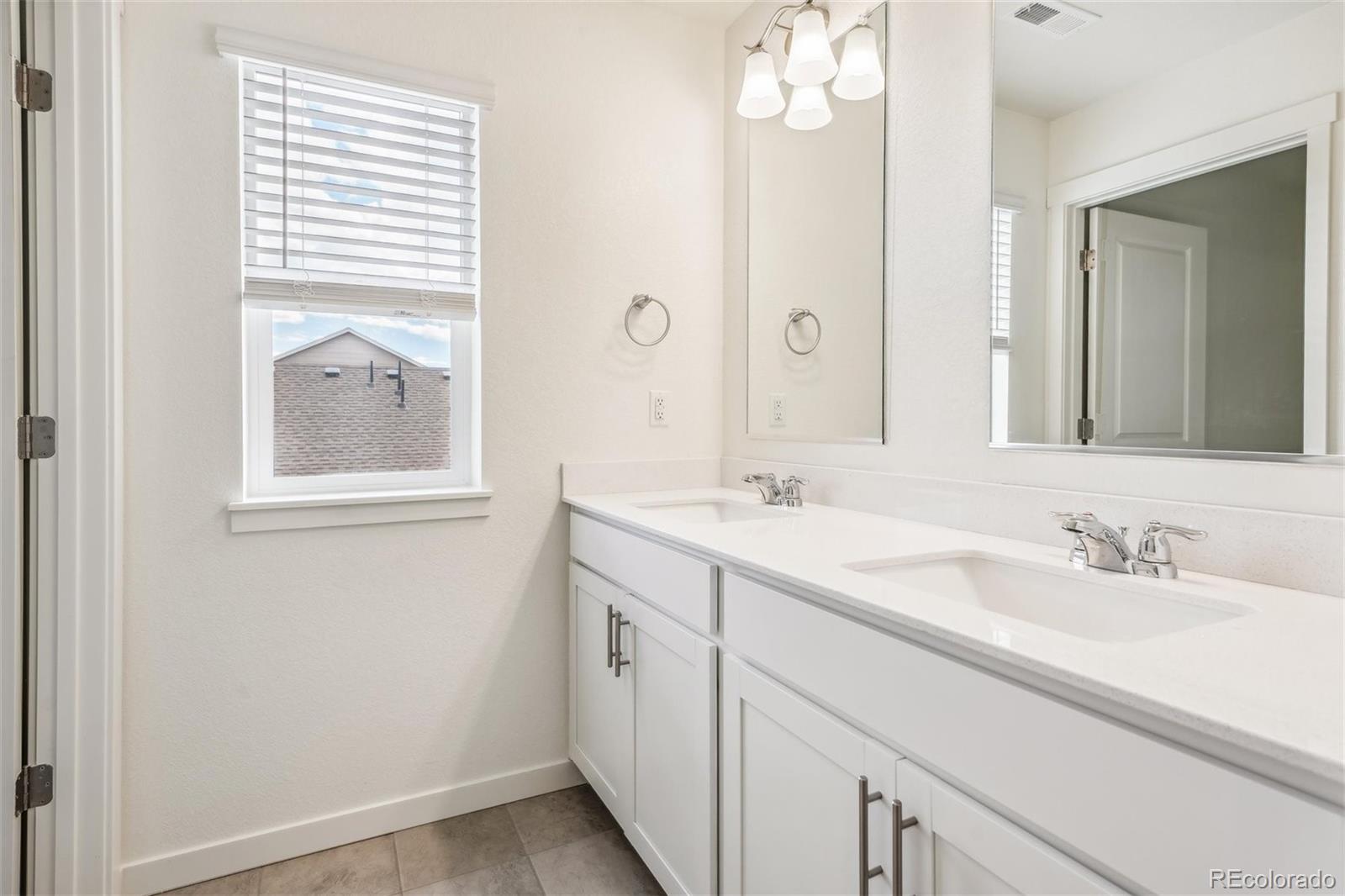 3482 Belleville Ridge Road Elizabeth, CO 80107 - Photo 17 of 21 a bathroom with a sink vanity and a mirror
