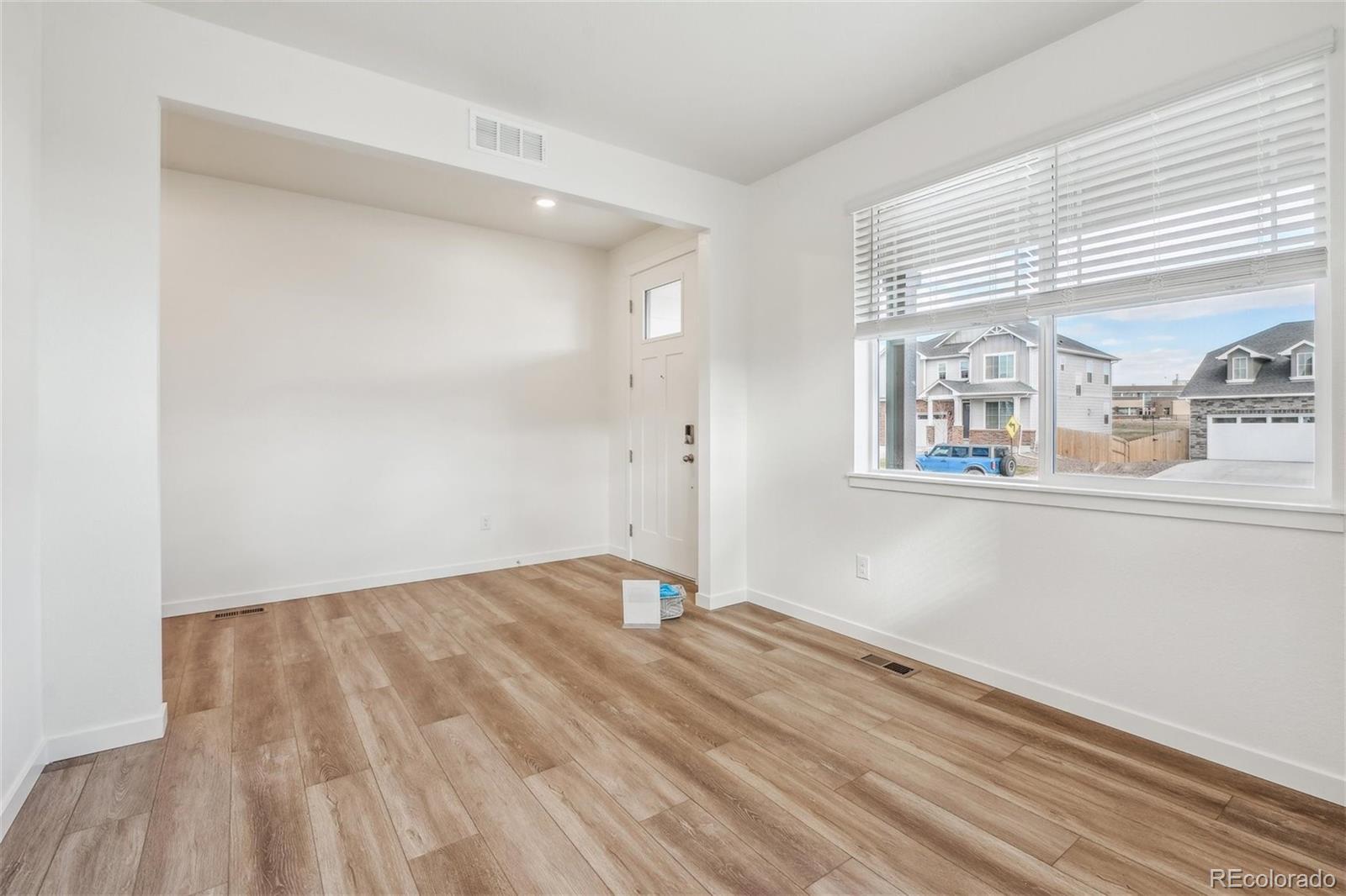 3482 Belleville Ridge Road Elizabeth, CO 80107 - Photo 3 of 21 a view of empty room with wooden floor and fan