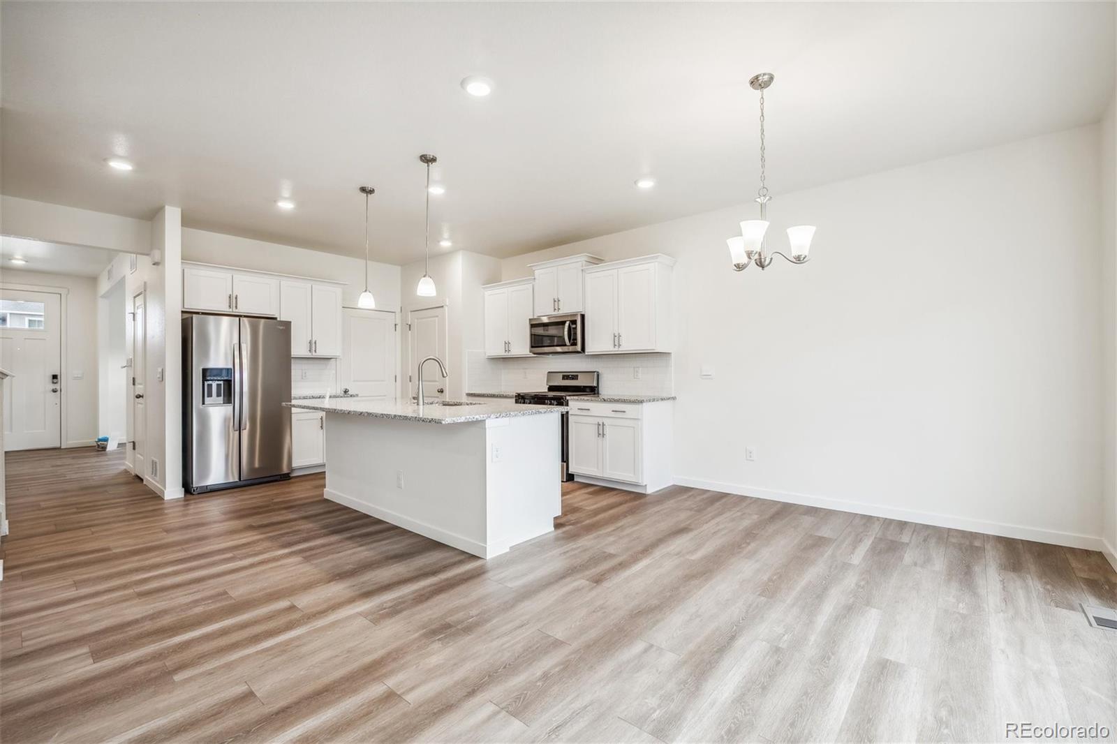 3482 Belleville Ridge Road Elizabeth, CO 80107 - Photo 5 of 21 a view of kitchen with granite countertop stainless steel appliances refrigerator oven stove and white cabinets