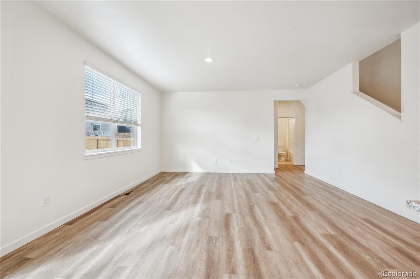 3482 Belleville Ridge Road Elizabeth, CO 80107 - Photo 8 of 21 a view of an empty room with wooden floor and a window
