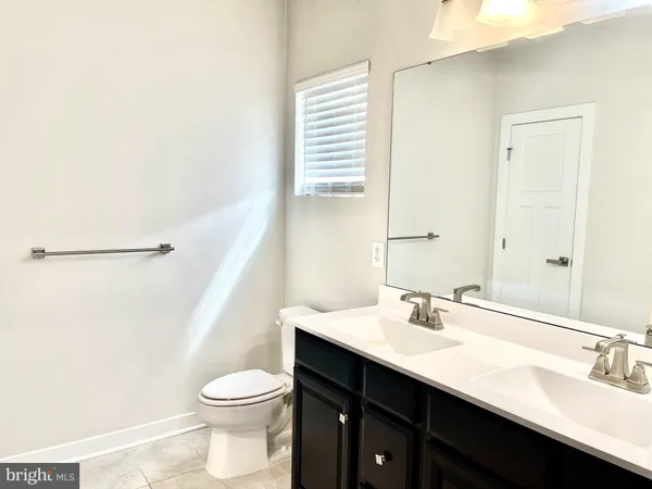 an empty room with fan and windows
