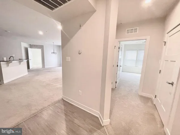 a kitchen with stainless steel appliances kitchen island granite countertop a refrigerator and a sink