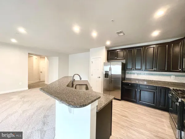 a view of a kitchen with a sink and cabinets