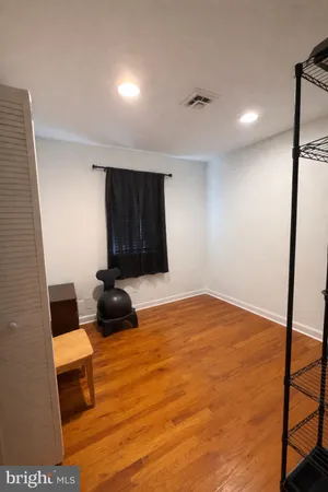 a room with a bed and a dresser