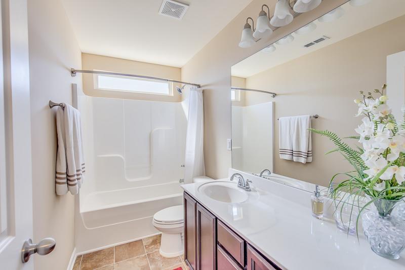 1007 Beverly Road Spring Hill, TN 37174 - Photo 20 of 24 a bathroom with a granite countertop sink toilet a large mirror a shower and a bathtub