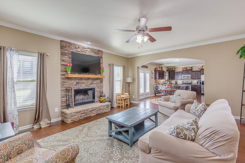1007 Beverly Road Spring Hill, TN 37174 - Photo 5 of 24 a living room with furniture a flat screen tv and a fireplace