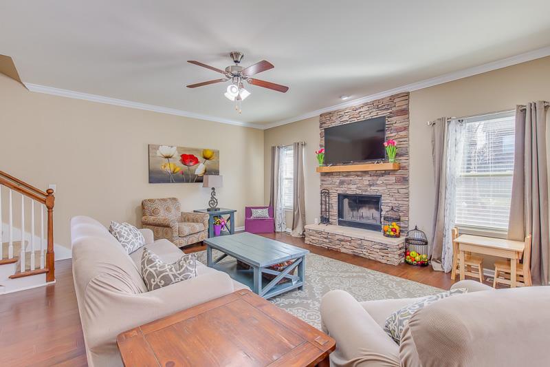 1007 Beverly Road Spring Hill, TN 37174 - Photo 6 of 24 a living room with furniture a flat screen tv and a fireplace