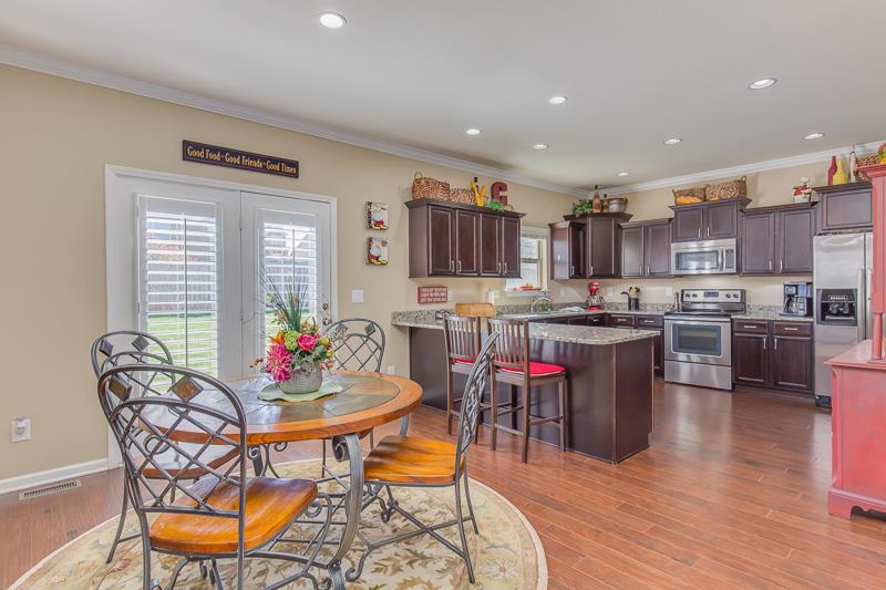 1007 Beverly Road Spring Hill, TN 37174 - Photo 9 of 24 a kitchen with stainless steel appliances a table and chairs in it