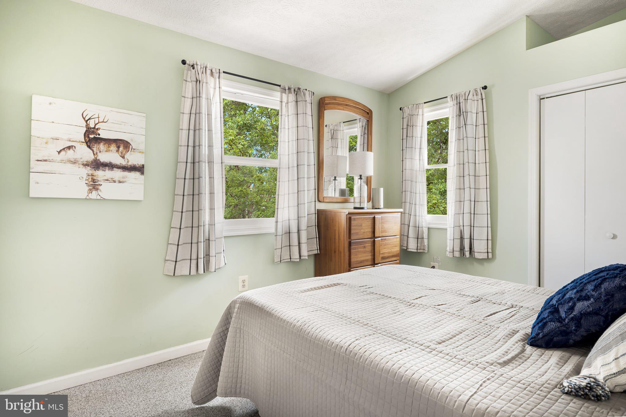 126 Flagstone Lane Berkeley Springs, WV 25411 - Photo 22 of 28 a bedroom with a large bed and a large window