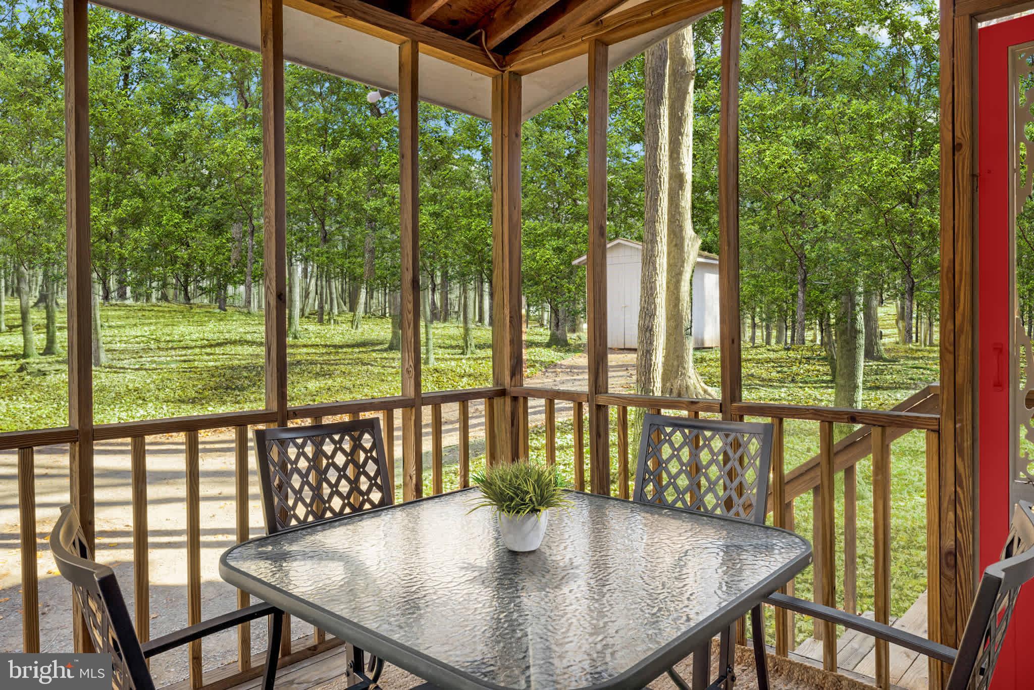 126 Flagstone Lane Berkeley Springs, WV 25411 - Photo 25 of 28 a view of a dining room with furniture window and outside view