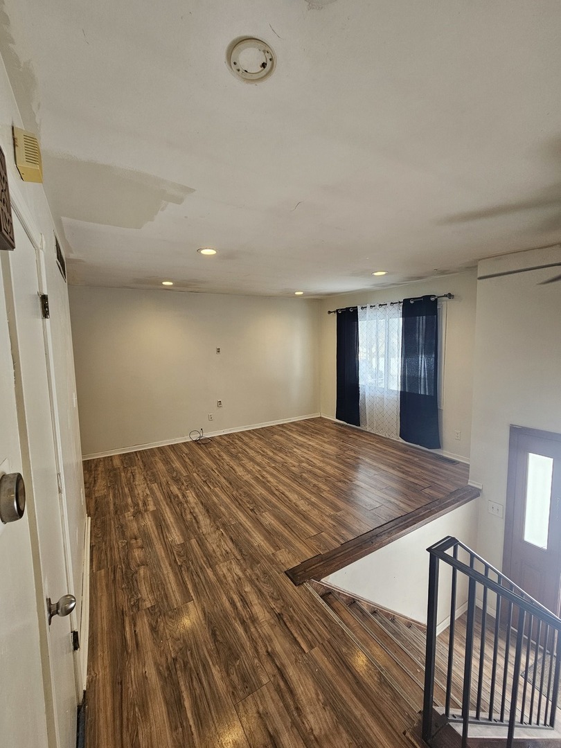 522 Manor Place Aurora, IL 60506 - Photo 3 of 16 an empty room with wooden floor