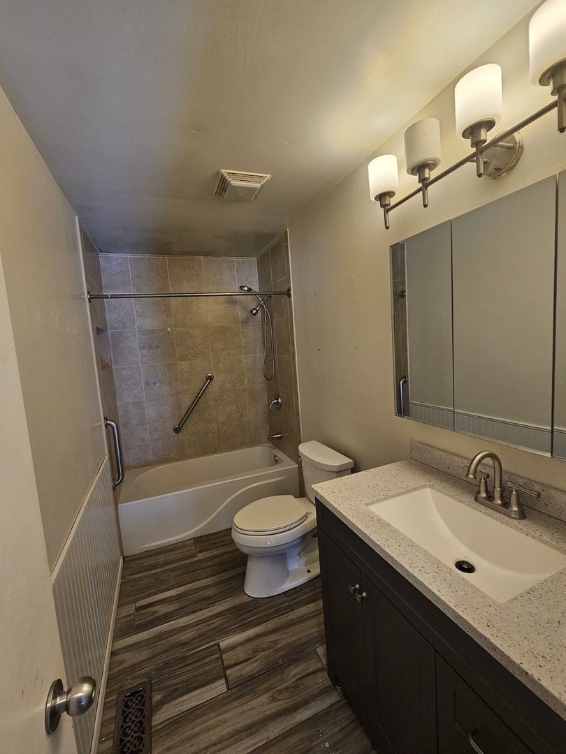 522 Manor Place Aurora, IL 60506 - Photo 7 of 16 a bathroom with a sink a toilet and shower