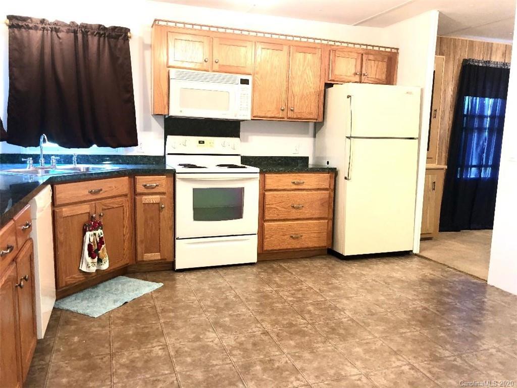 901 Clontz Long Road Monroe, NC 28110 - Photo 15 of 35 a kitchen with appliances a refrigerator and a stove