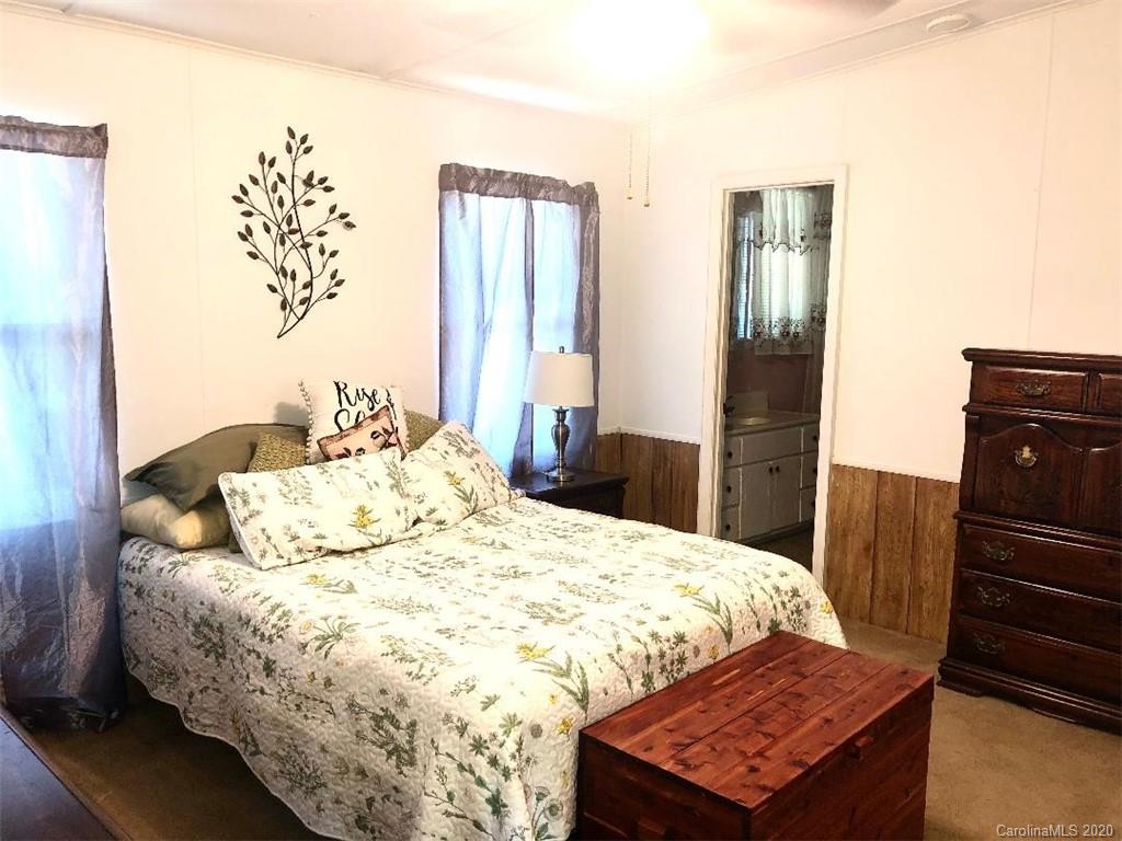 901 Clontz Long Road Monroe, NC 28110 - Photo 21 of 35 a bedroom with a bed and wooden floor