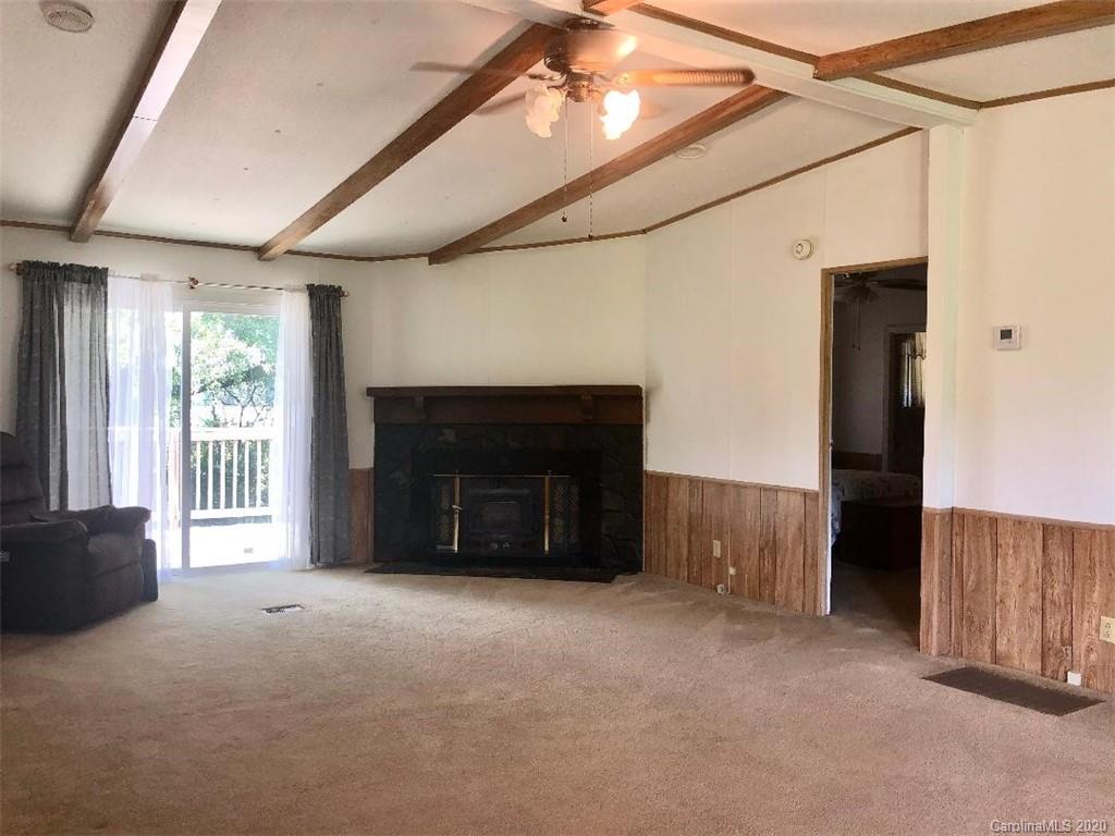 901 Clontz Long Road Monroe, NC 28110 - Photo 9 of 35 a view of an empty room with a fireplace and a window