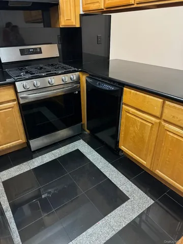 a stove top oven sitting inside of a kitchen