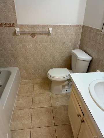 a bathroom with a sink toilet and mirror