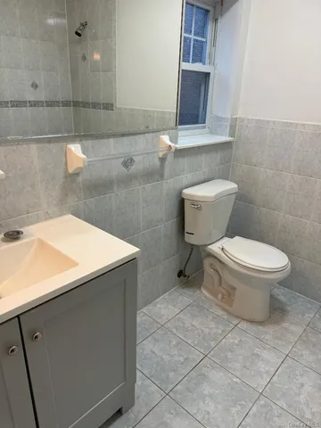 a bathroom with a sink vanity and tub