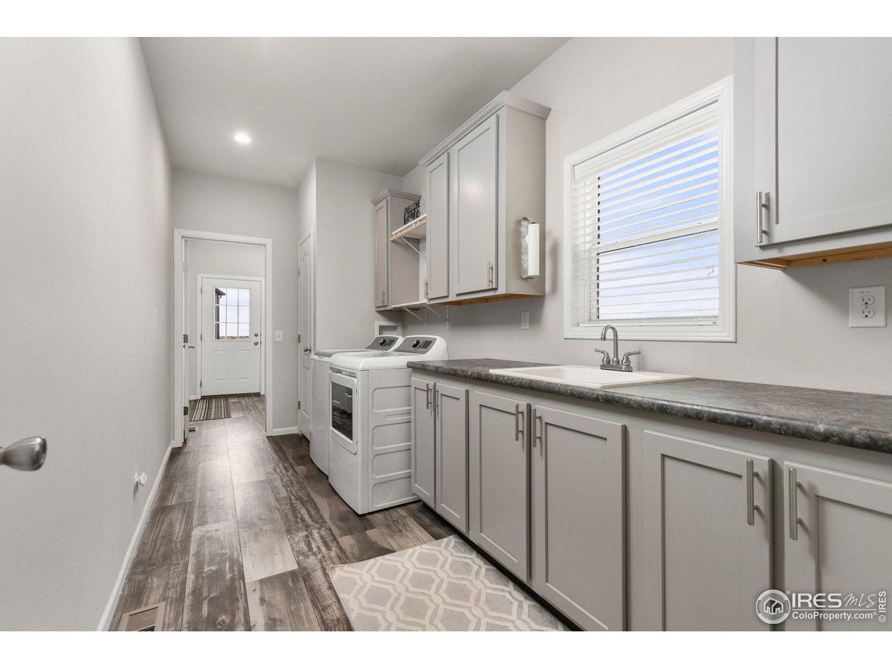 16244 County Road 94 Pierce, CO 80650 - Photo 12 of 37 a open kitchen with granite countertop white cabinets and sink