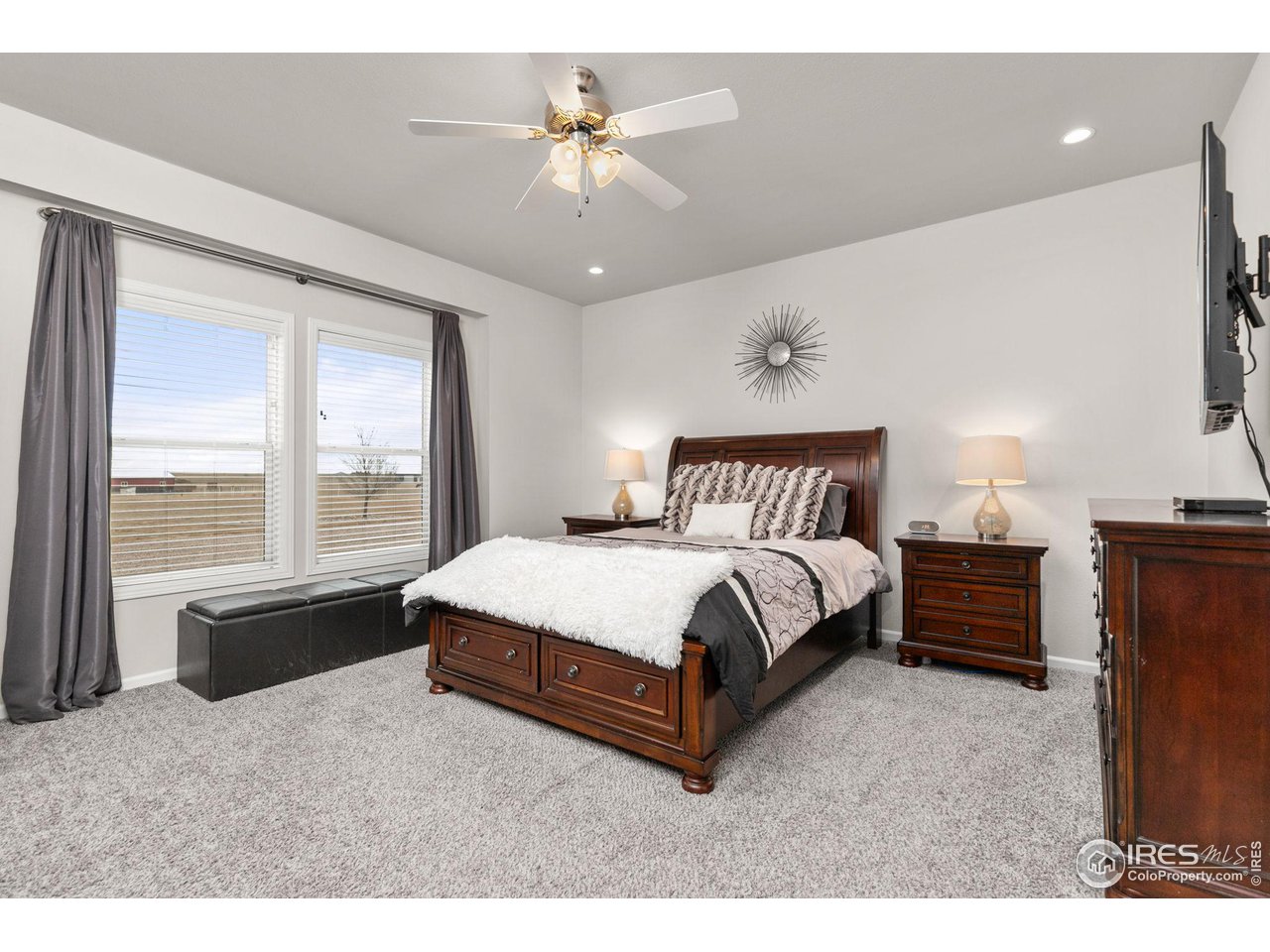 16244 County Road 94 Pierce, CO 80650 - Photo 15 of 37 a spacious bedroom with a bed and a chandelier
