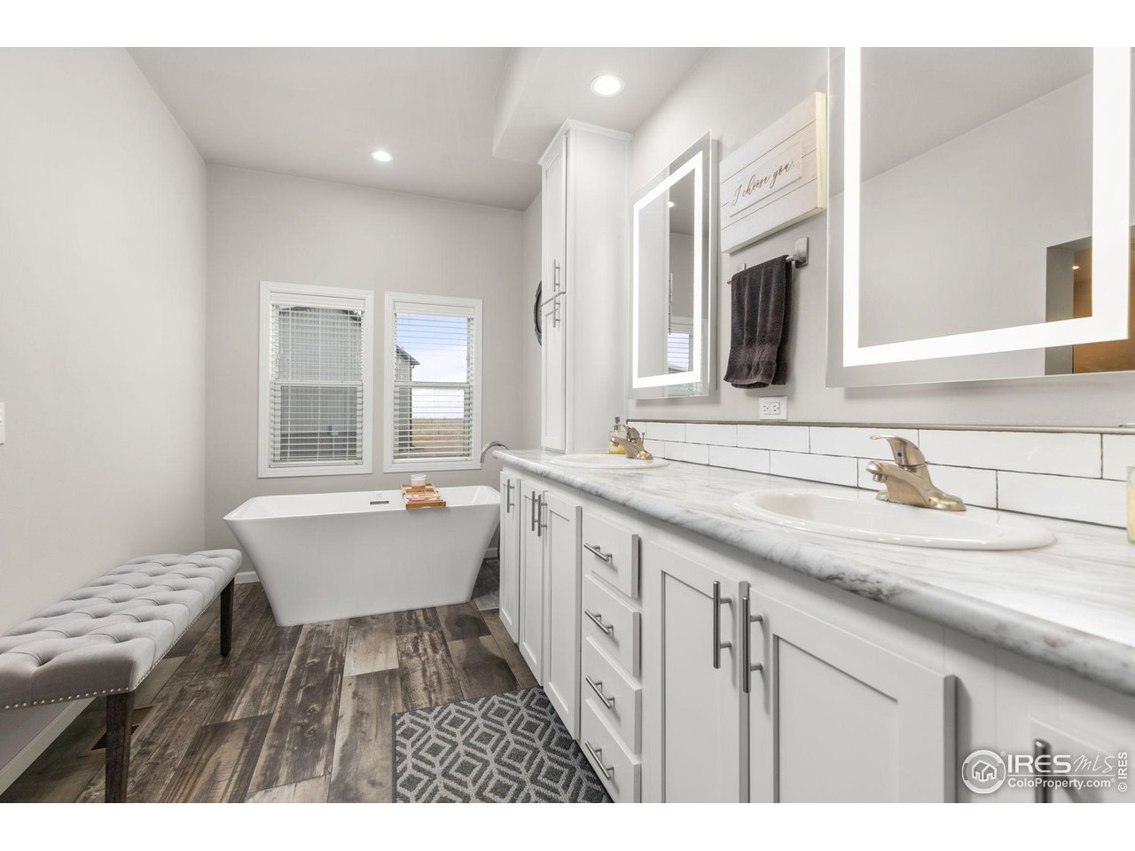 16244 County Road 94 Pierce, CO 80650 - Photo 16 of 37 a bathroom with a granite countertop sink mirror and bathtub