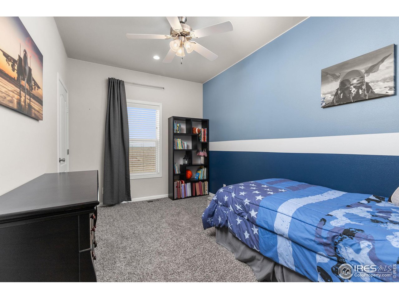 16244 County Road 94 Pierce, CO 80650 - Photo 18 of 37 a bedroom with a bed a wall painting and a book shelf