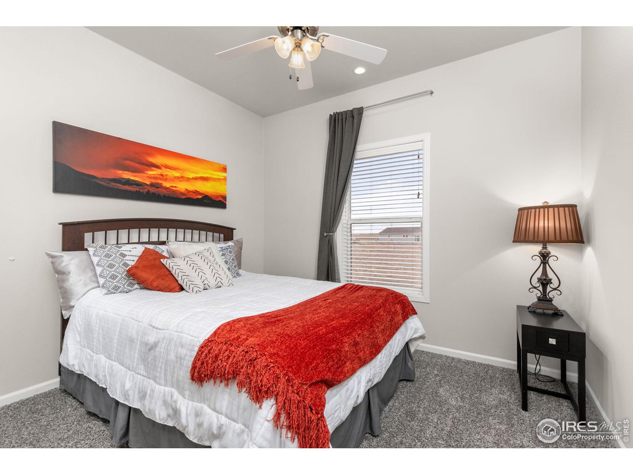 16244 County Road 94 Pierce, CO 80650 - Photo 20 of 37 a bedroom with a bed a lamp and a window