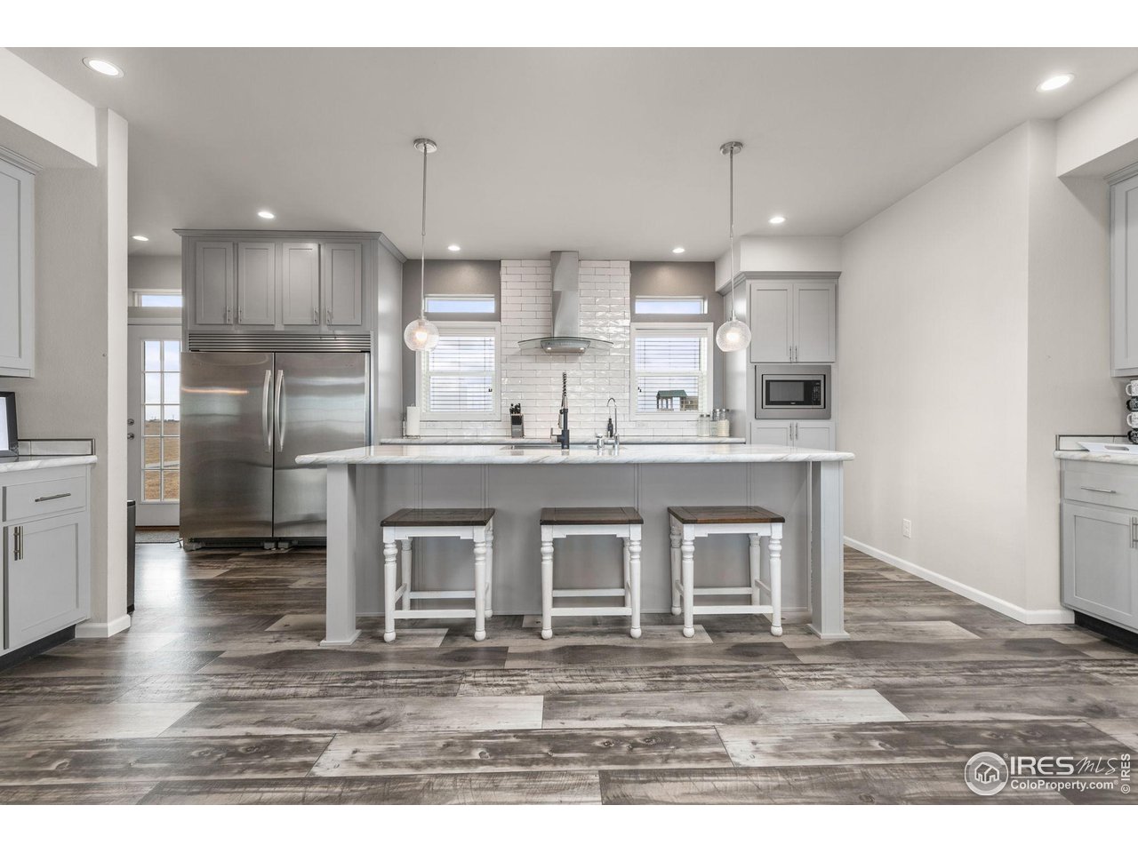 16244 County Road 94 Pierce, CO 80650 - Photo 4 of 37 a open kitchen with kitchen island granite countertop a sink cabinets and stainless steel appliances
