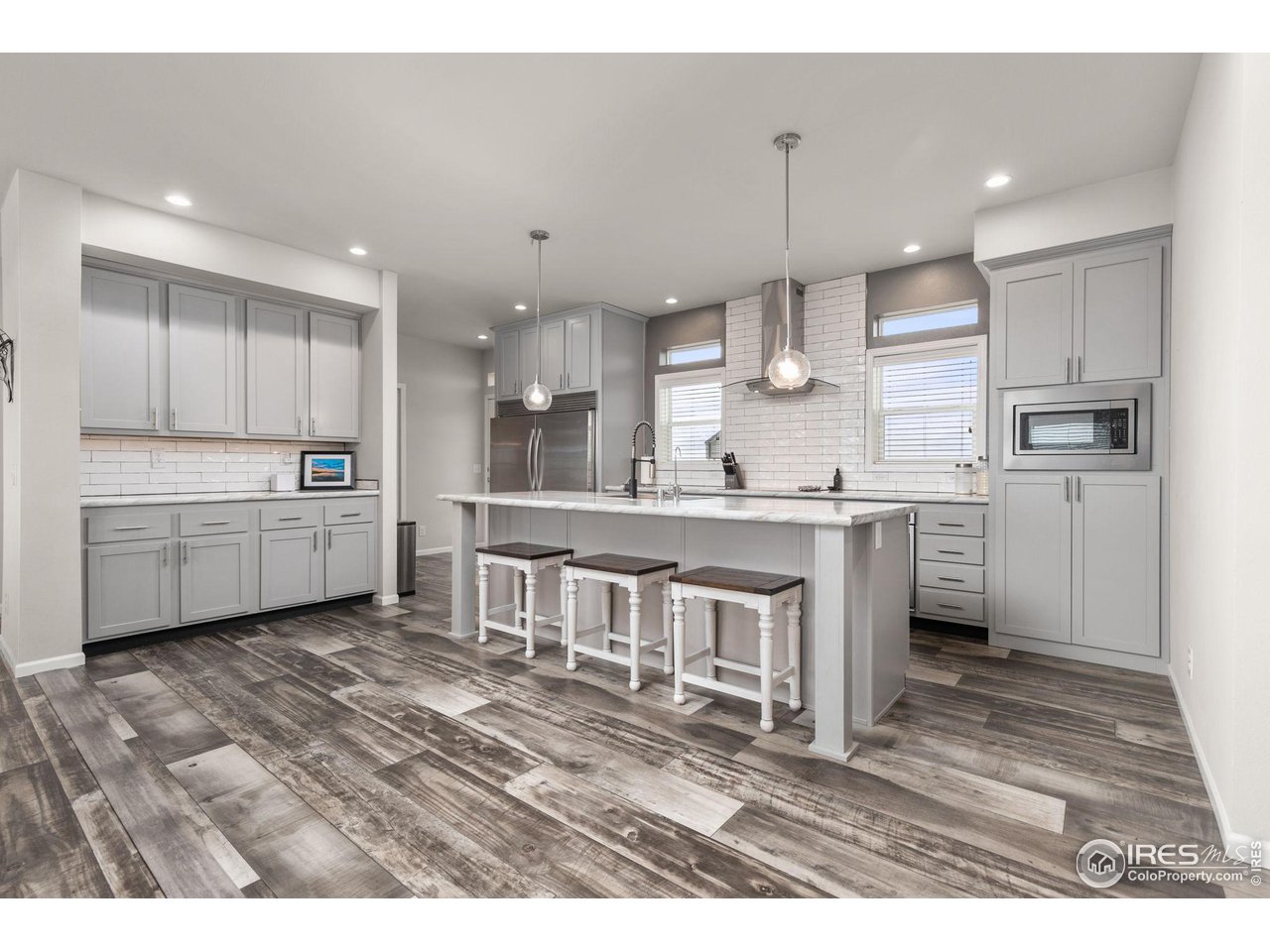 16244 County Road 94 Pierce, CO 80650 - Photo 5 of 37 a kitchen with kitchen island a sink stainless steel appliances and cabinets
