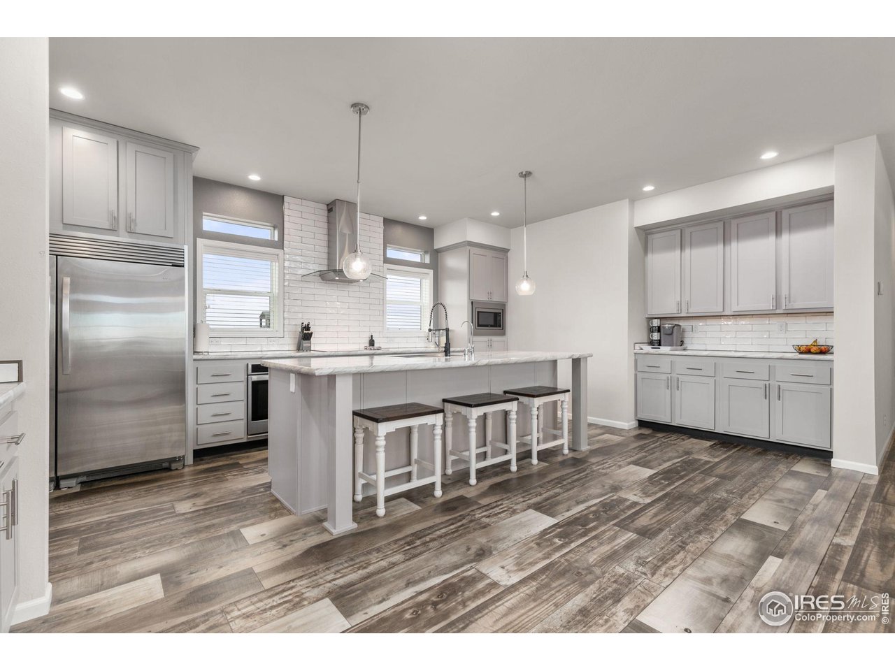 16244 County Road 94 Pierce, CO 80650 - Photo 6 of 37 a kitchen with kitchen island a sink stainless steel appliances and cabinets