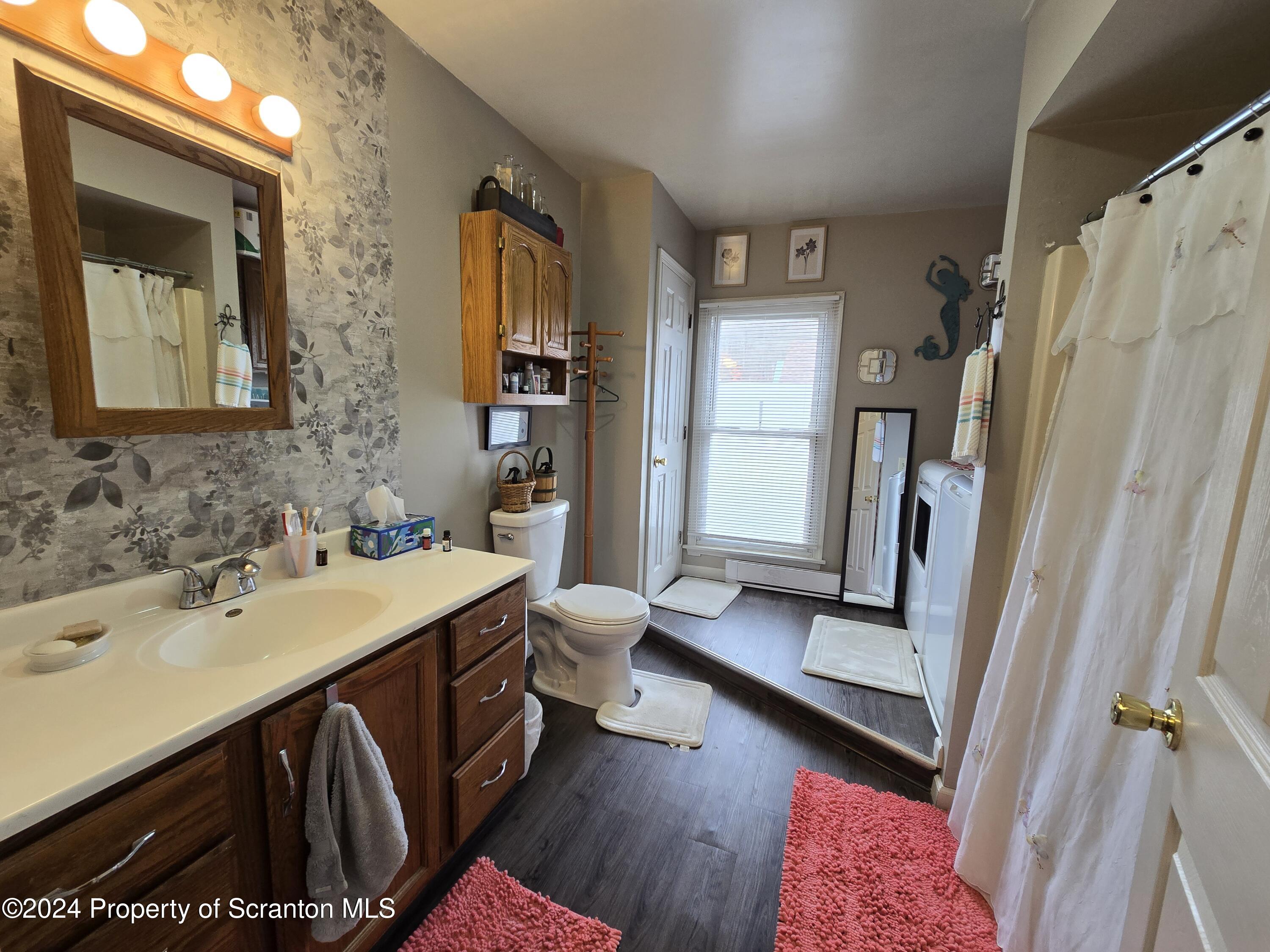 118 Main Street Hop Bottom, PA 18824 - Photo 11 of 35 a bathroom with a sink a mirror and a shower