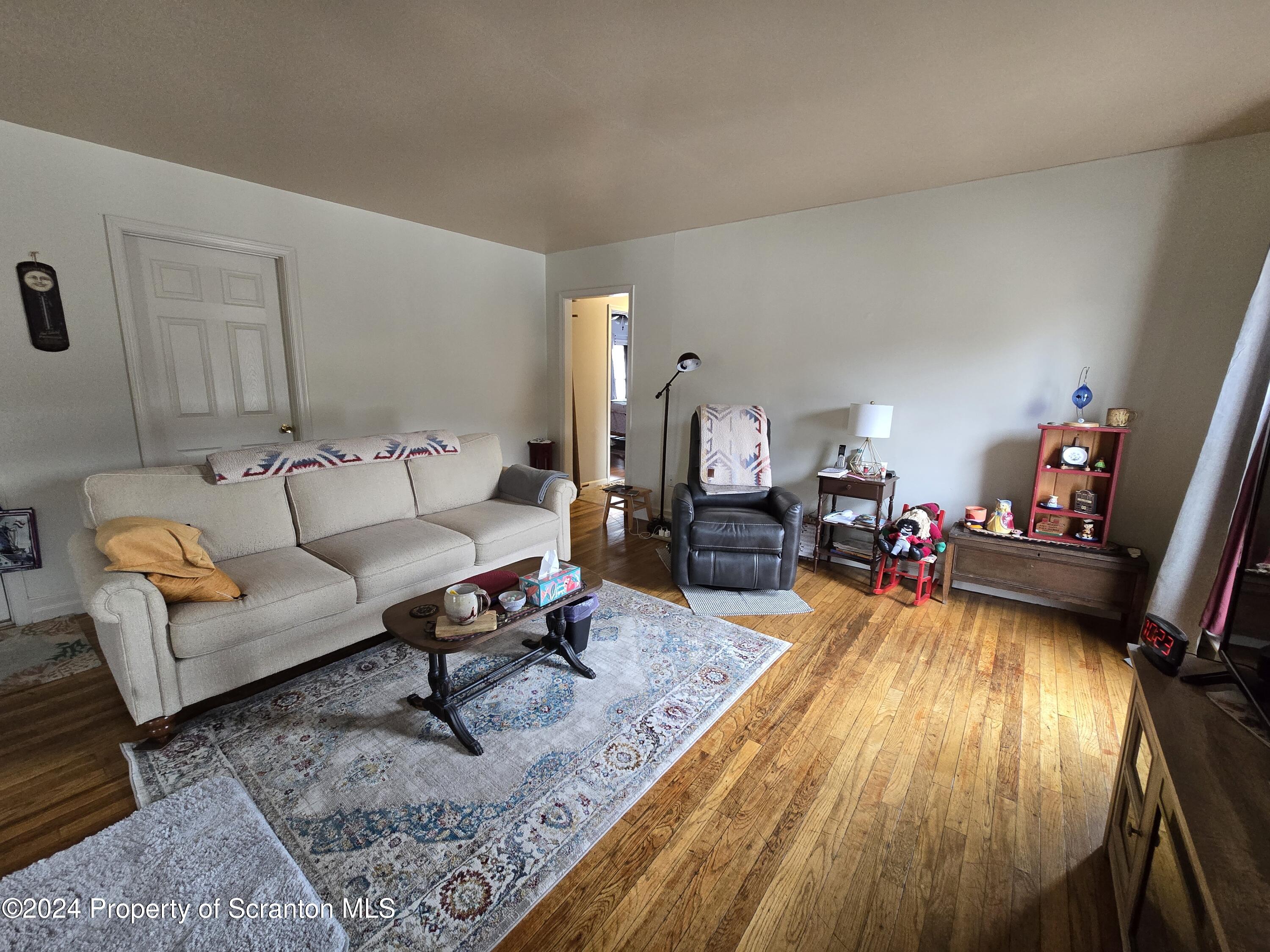 118 Main Street Hop Bottom, PA 18824 - Photo 15 of 35 a living room with furniture and a wooden floor