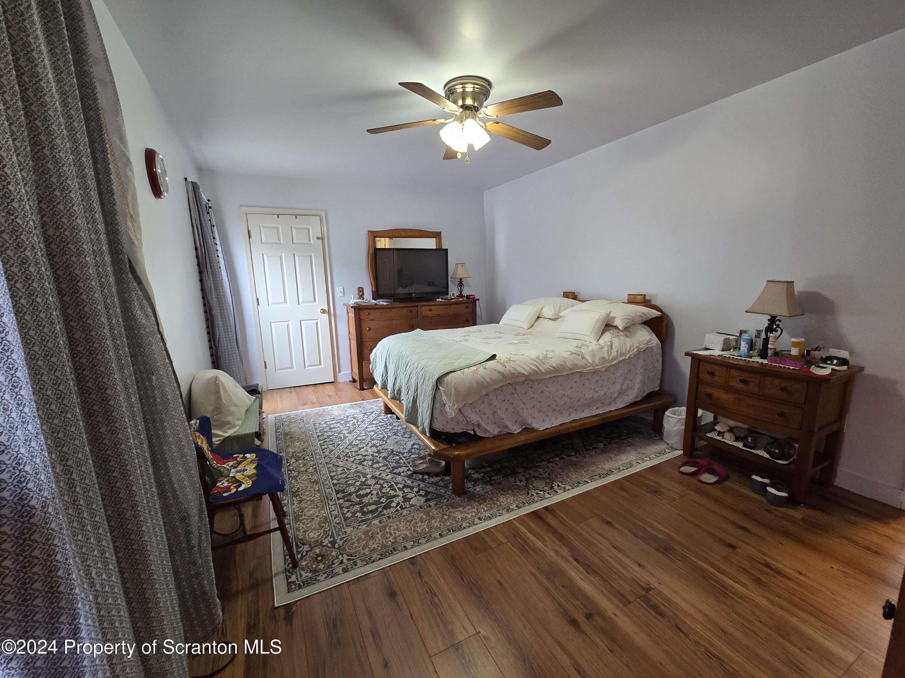118 Main Street Hop Bottom, PA 18824 - Photo 20 of 35 a bed room with a bed window and a chair