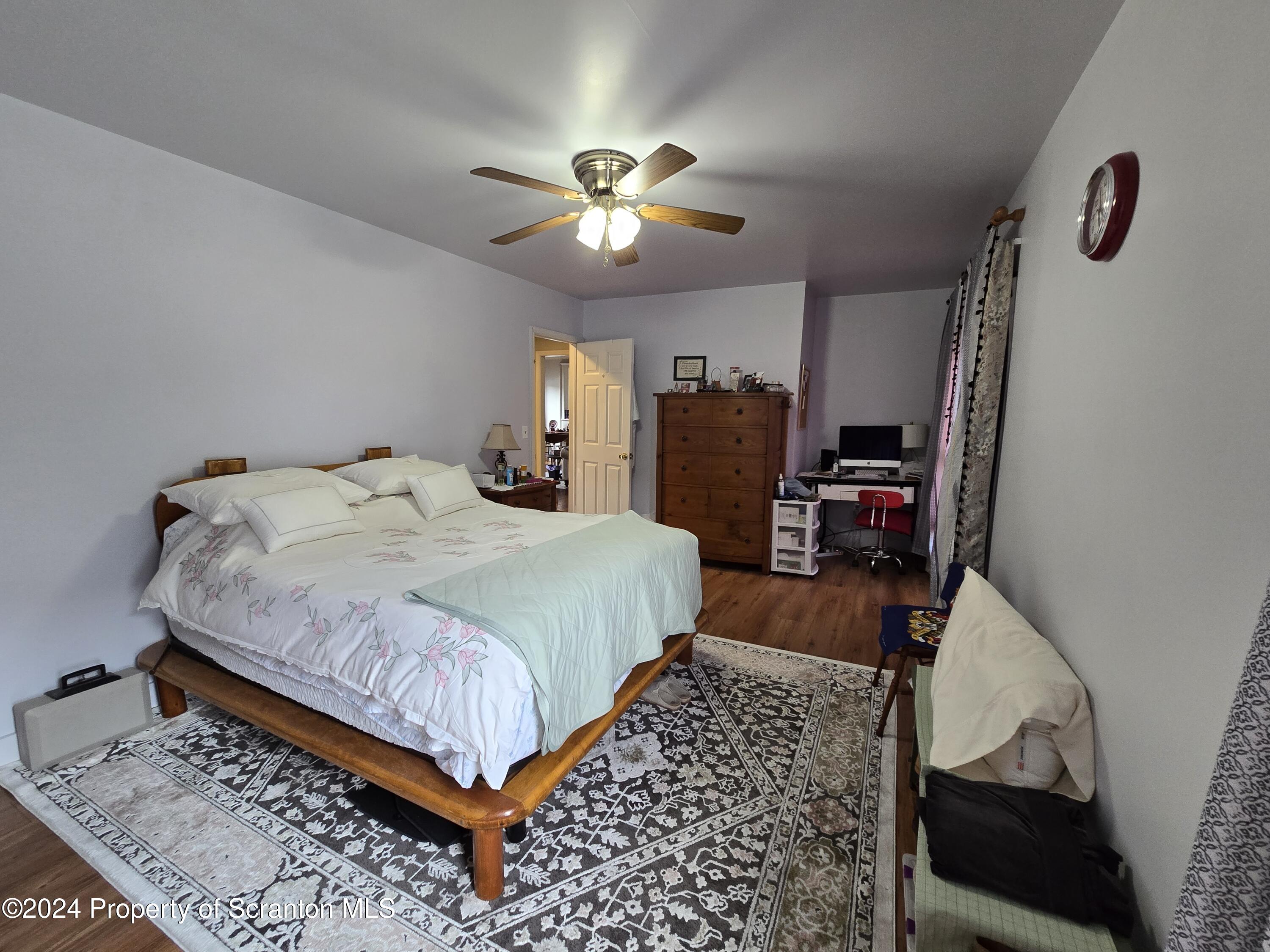 118 Main Street Hop Bottom, PA 18824 - Photo 21 of 35 a bedroom with a bed and a chandelier