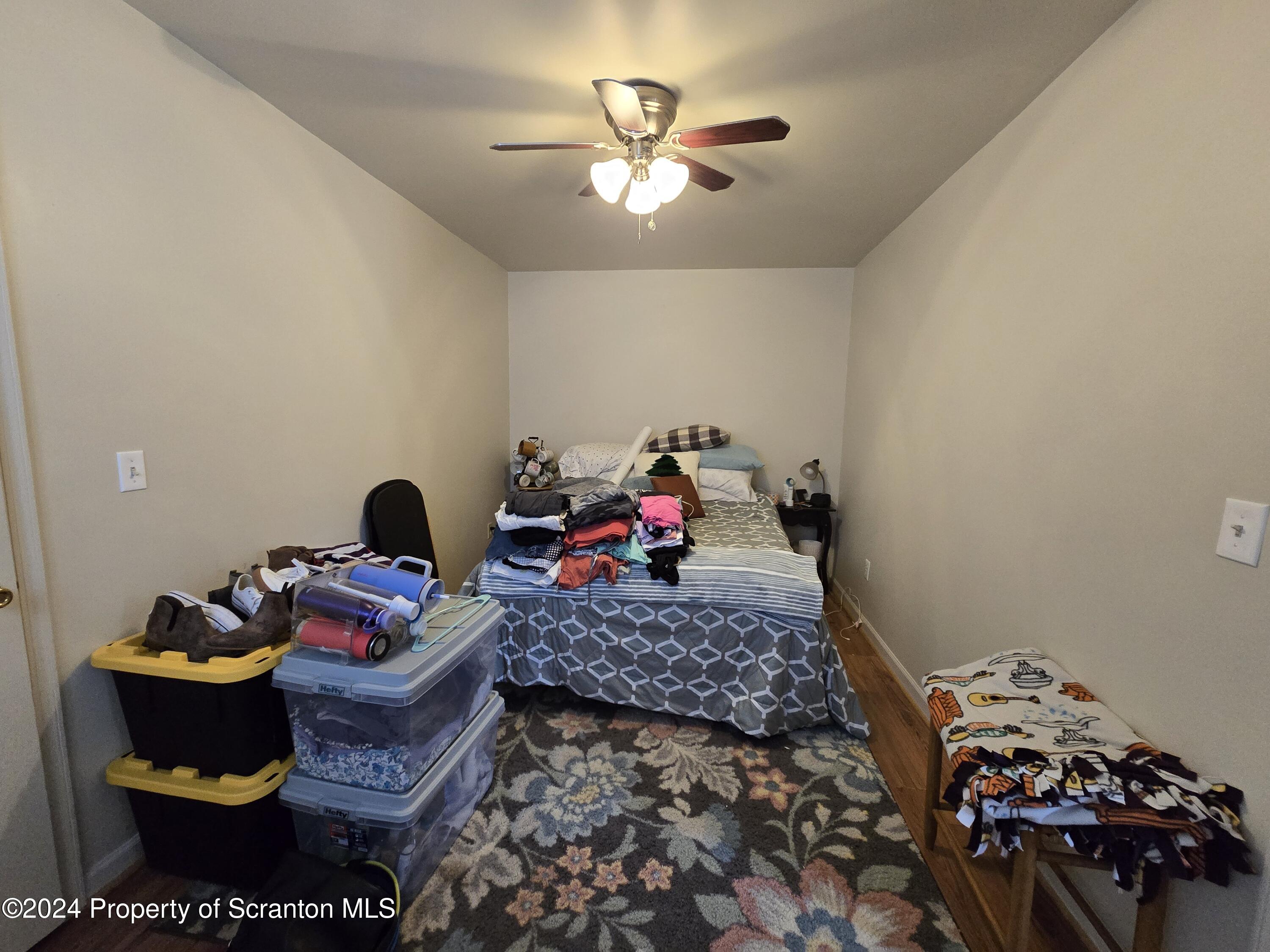 118 Main Street Hop Bottom, PA 18824 - Photo 22 of 35 a bed room with a bed and a chandelier
