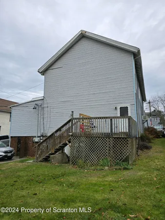 a view of a house with a wooden deck