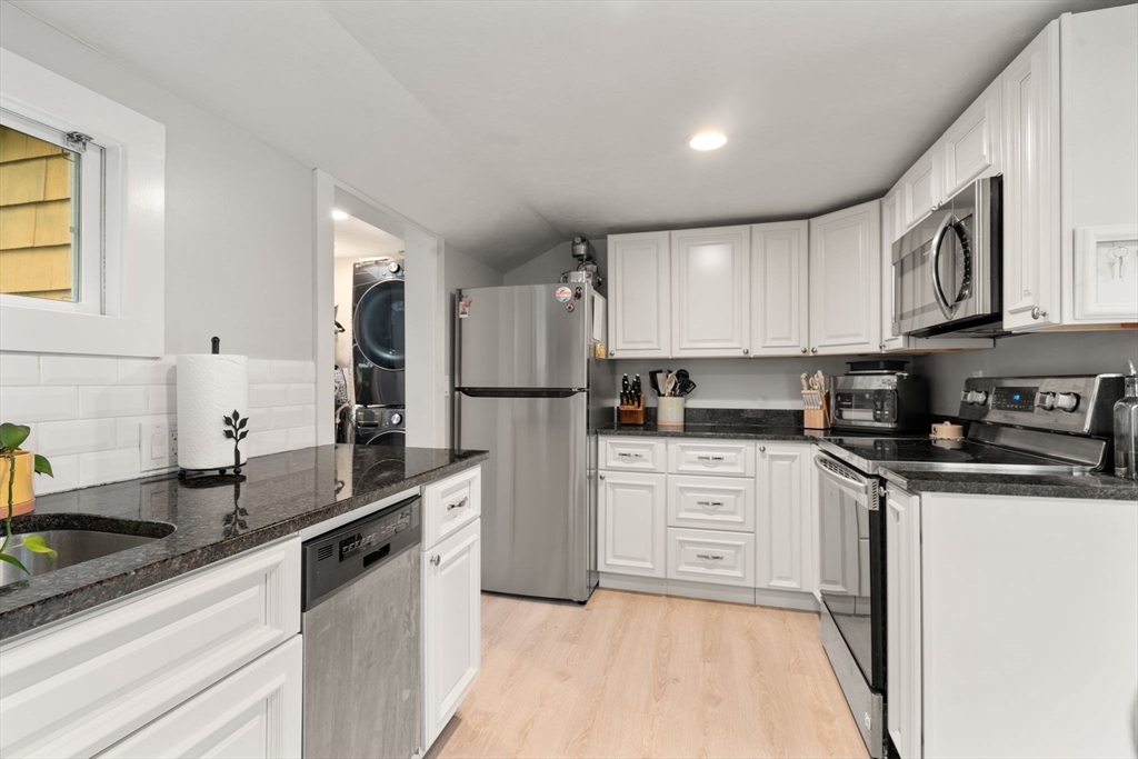 7 Indian Neck Road Wareham, MA 02571 - Photo 14 of 34 a kitchen with granite countertop a sink stainless steel appliances and white cabinets