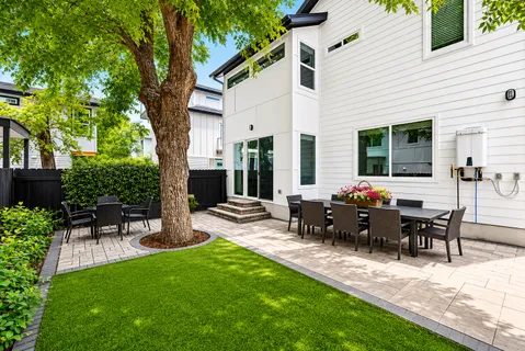 a view of a house with backyard sitting area and garden