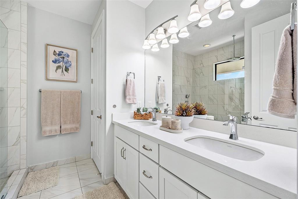 608 Windward Circle Boynton Beach, FL 33435 - Photo 12 of 26 a bathroom with double vanity sinks a vanity a lamp and a mirror