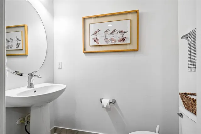 a view of a hallway with wooden floor and entryway