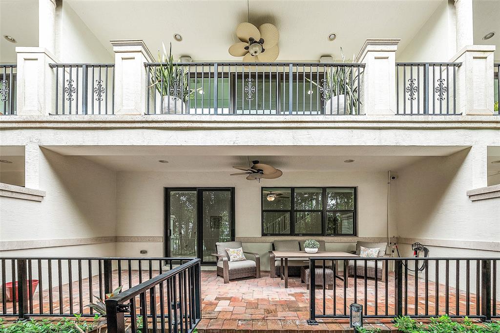 608 Windward Circle Boynton Beach, FL 33435 - Photo 3 of 26 a view of a brick house with large windows and furniture