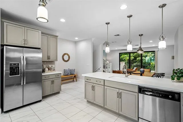 a spacious bathroom with a granite countertop sink a mirror and a shower