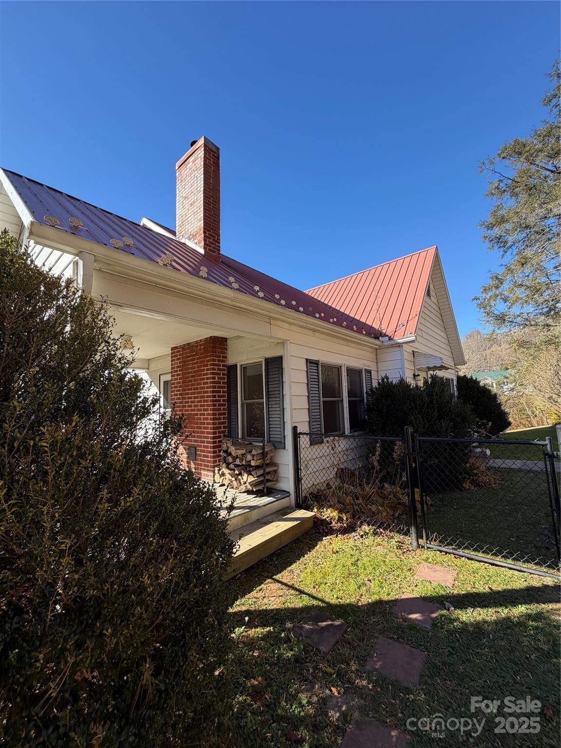 202 Snow Hill Road Bakersville, NC 28705 - Photo 20 of 27 a view of a house with backyard porch and sitting area