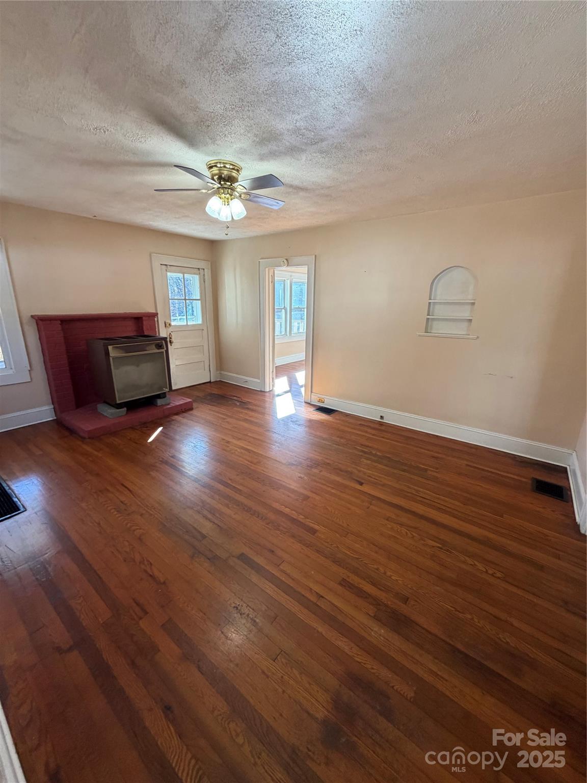 202 Snow Hill Road Bakersville, NC 28705 - Photo 2 of 27 wooden floor in an empty room with a window
