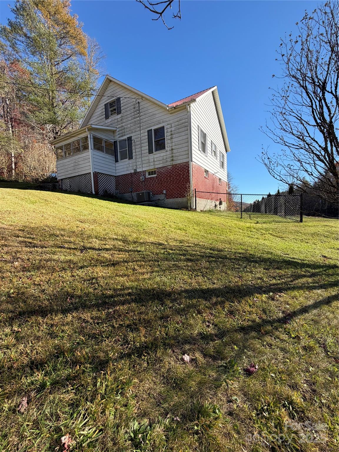 202 Snow Hill Road Bakersville, NC 28705 - Photo 26 of 27 a front view of house with yard and trees in the background