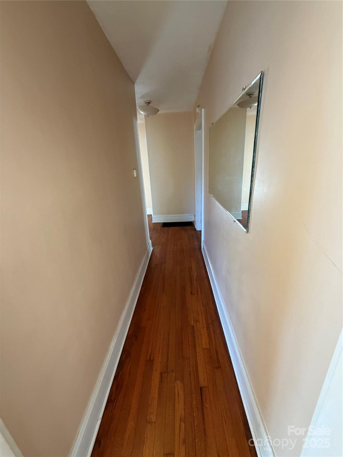 202 Snow Hill Road Bakersville, NC 28705 - Photo 5 of 27 a view of a hallway with wooden floor and a bathroom