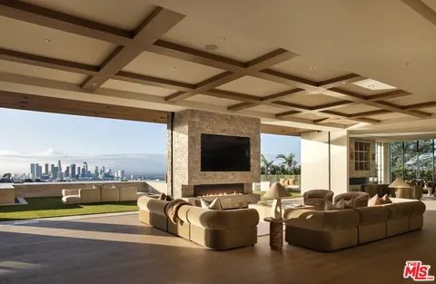 a living room with furniture fireplace and window