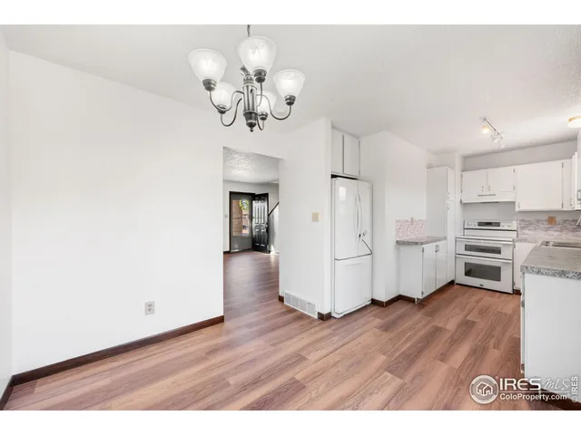 a view of a kitchen with wooden floor